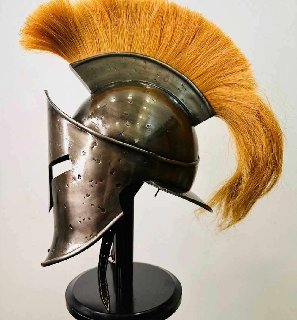 a helmet with a yellow hair on top of it