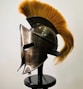 a helmet with a red tail on a stand