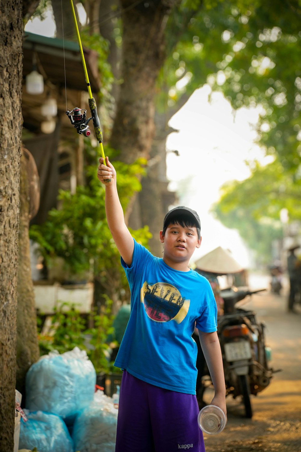 a young boy holding onto a fishing pole