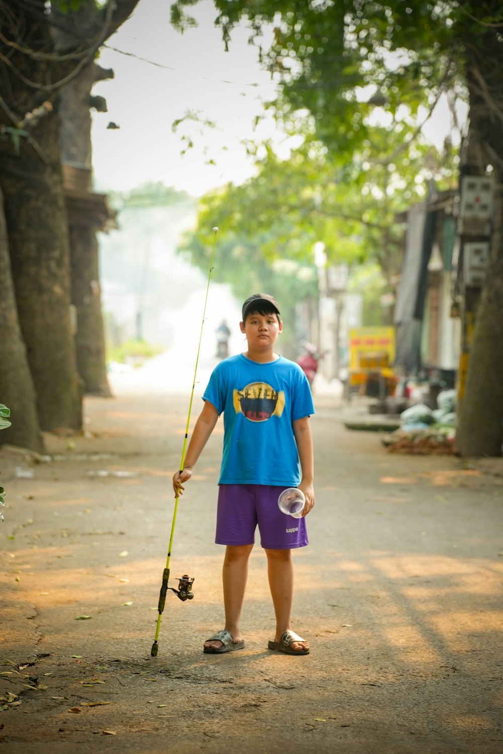a young man holding a fishing pole and a fishing pole