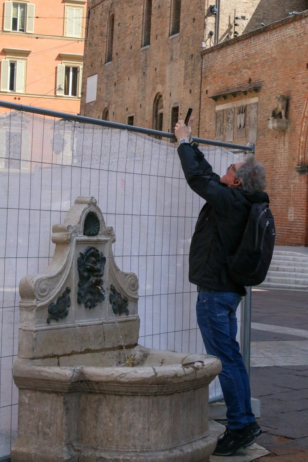 a man taking a picture of a statue