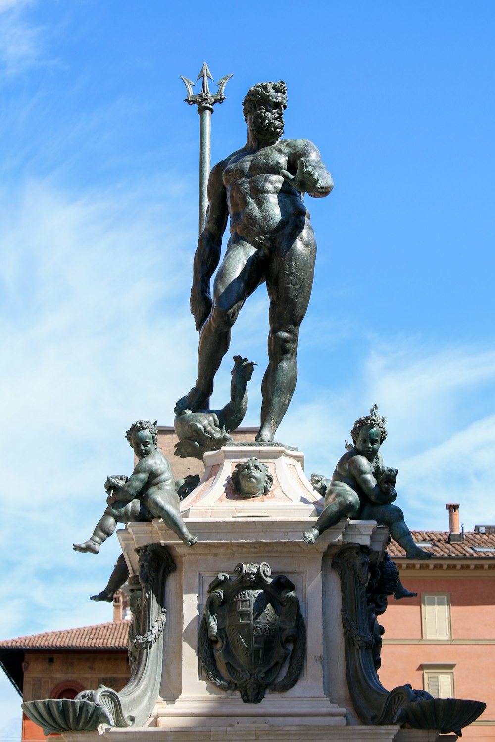 a statue of a man standing on top of a fountain