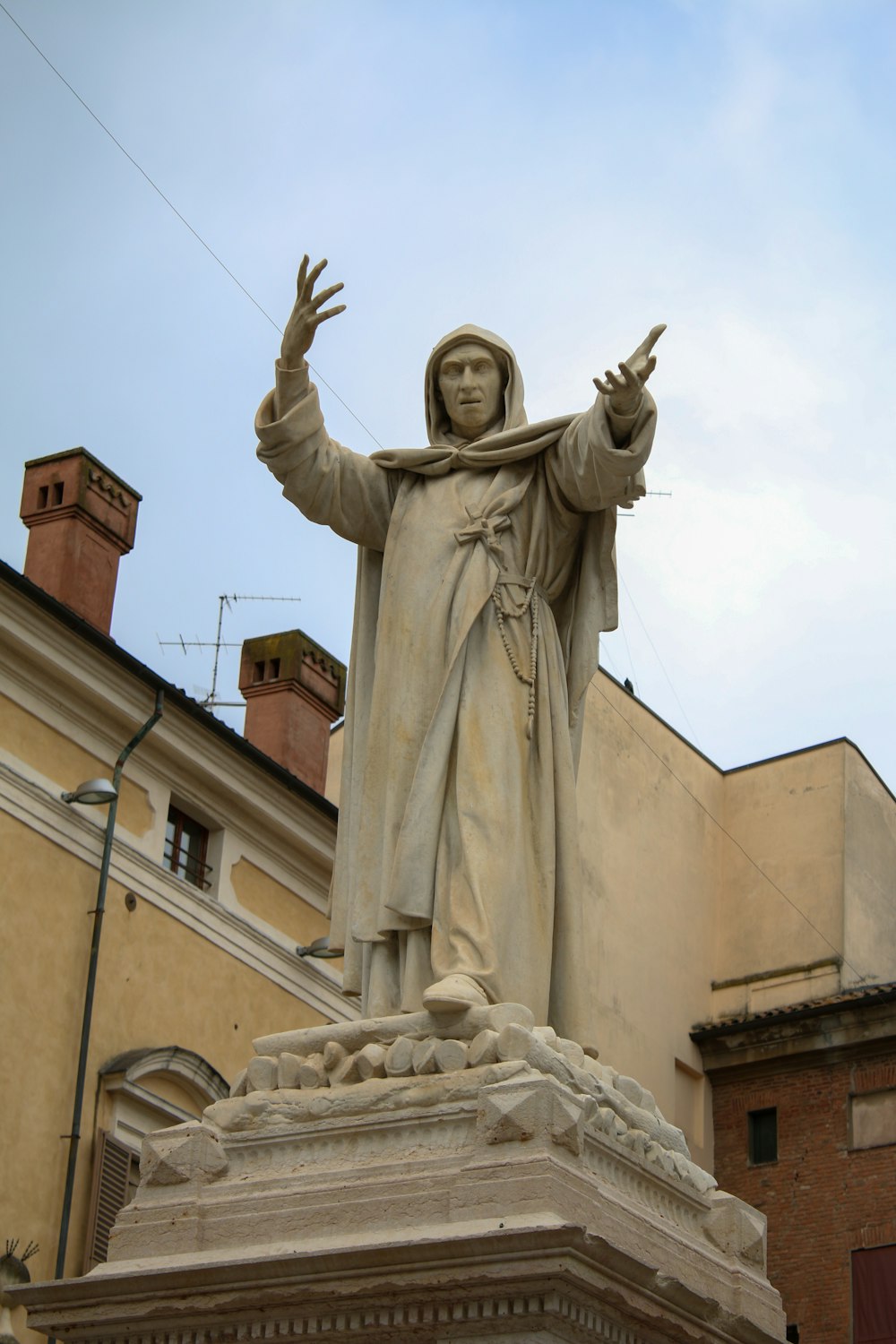 a statue of a man with his hands in the air