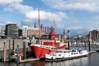 a large red and white boat docked in a harbor