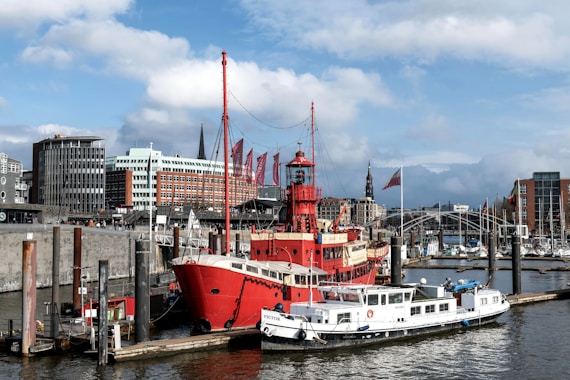 a large red and white boat docked in a harbor