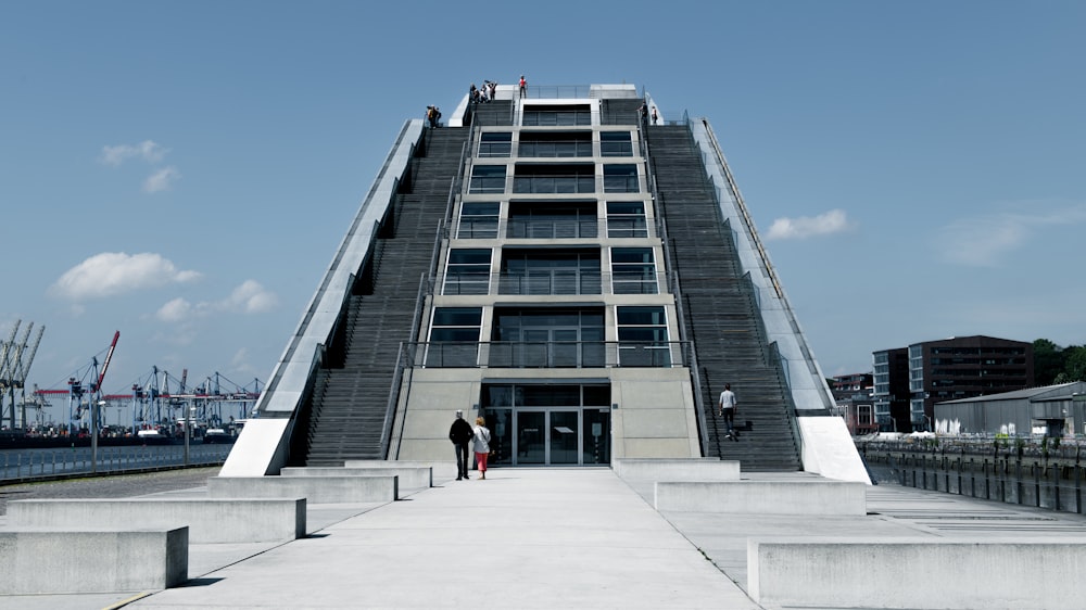 a very tall building with some people standing in front of it