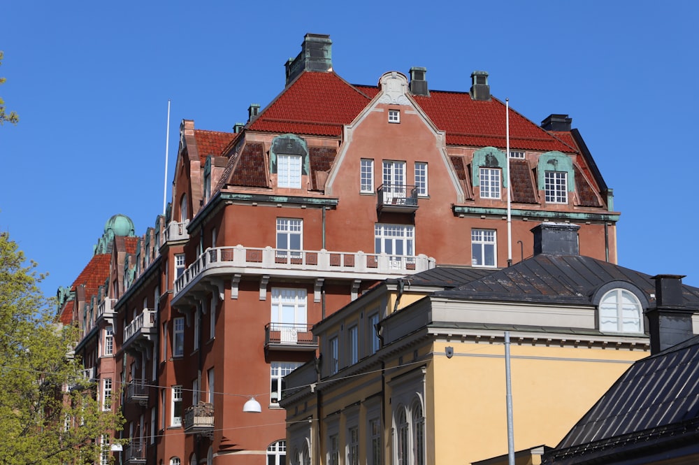 a large building with a red roof and many windows