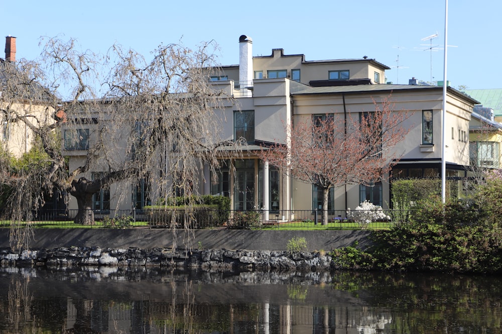 a large house sitting next to a body of water