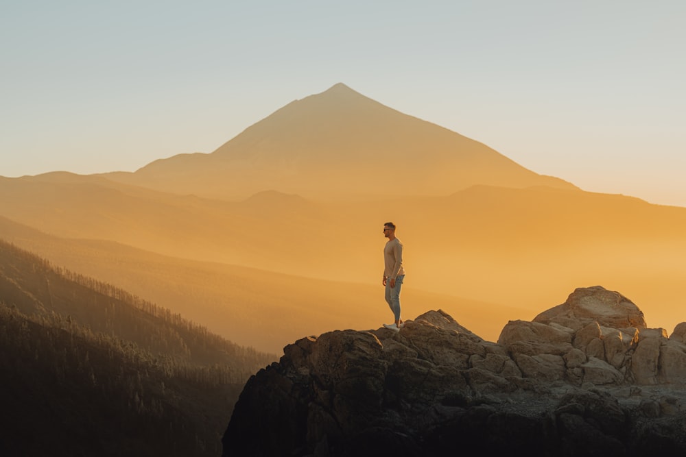 a man standing on top of a mountain