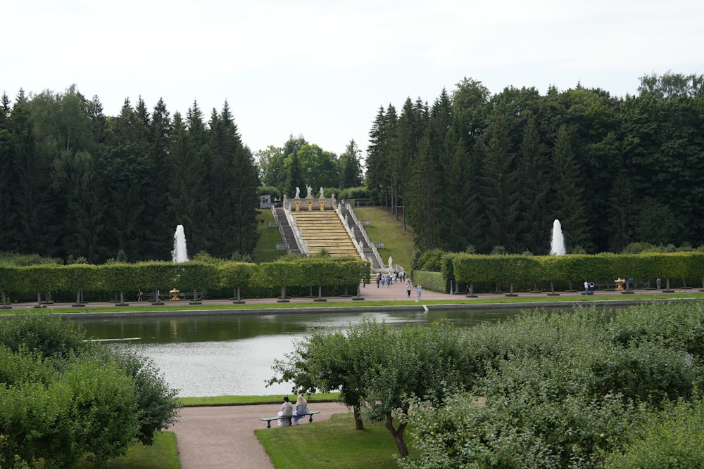 a view of a park with a lake and stairs