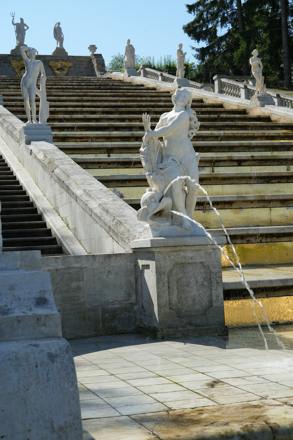 a fountain in front of a set of stone steps