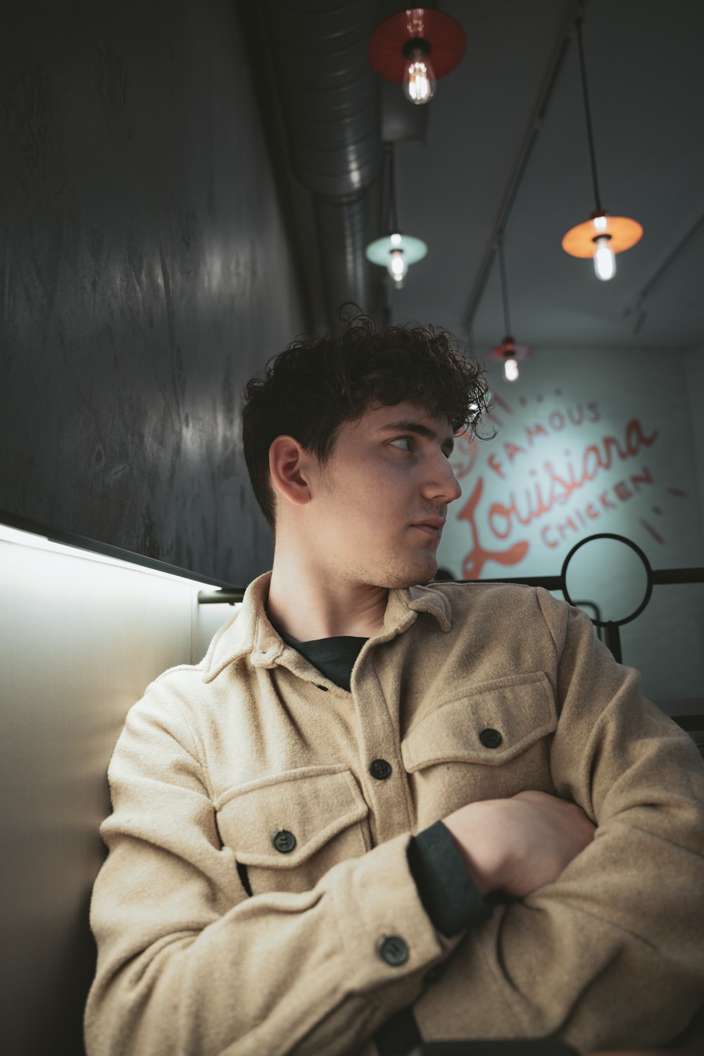 a man sitting in a booth with his arms crossed