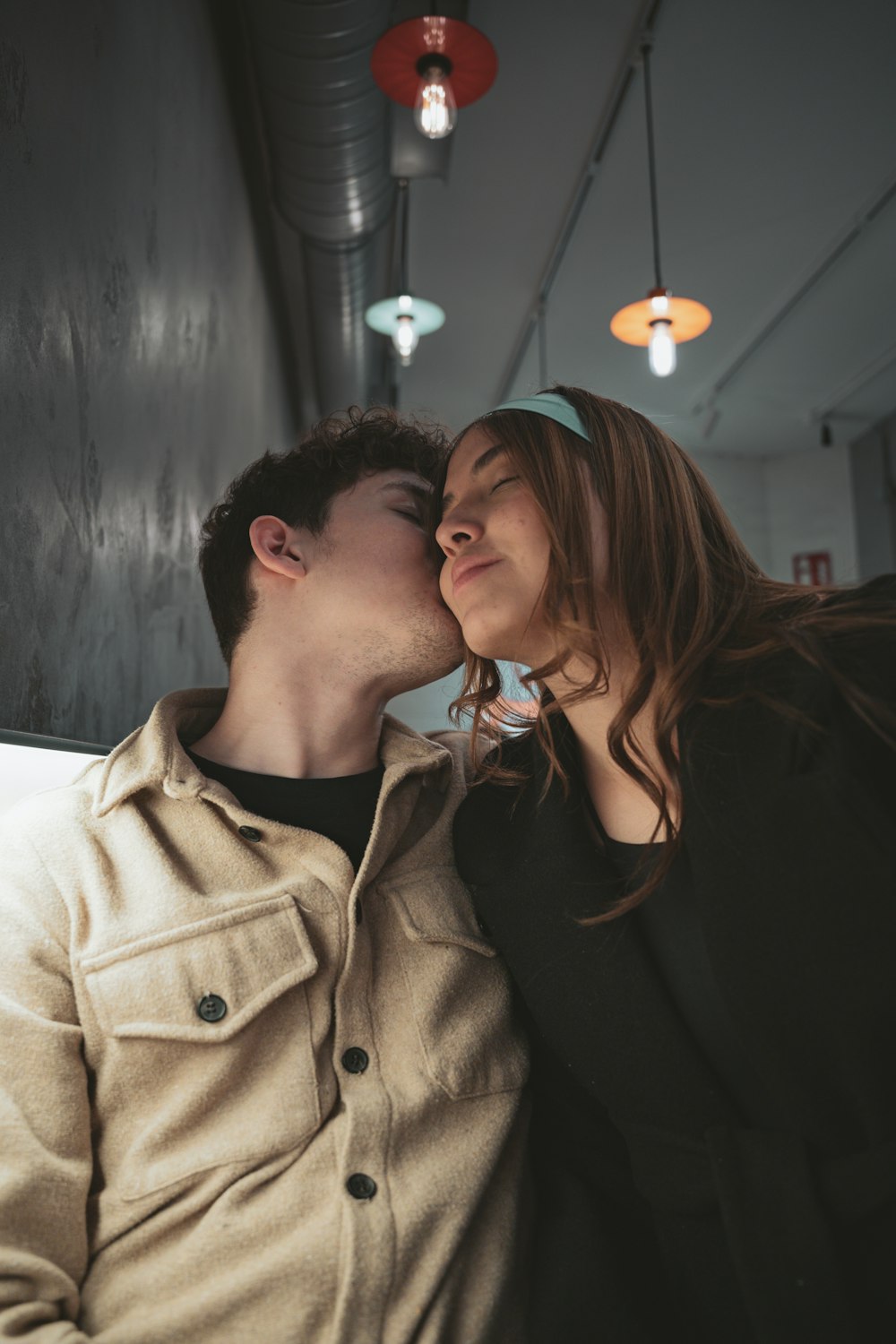 a man kissing a woman on the cheek