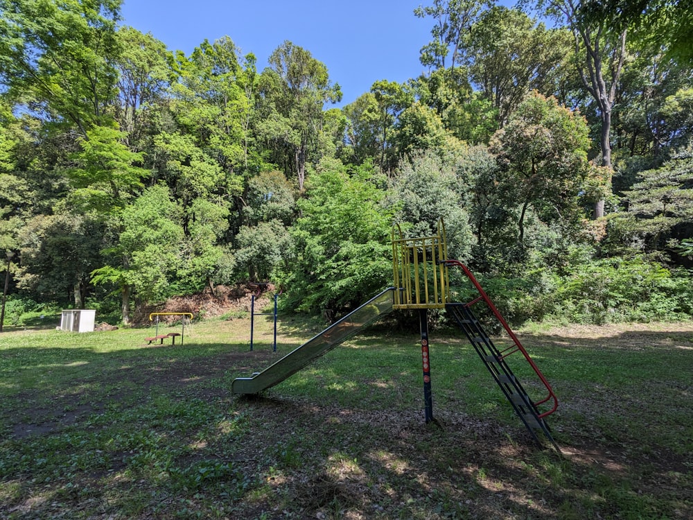 a playground in the middle of a wooded area
