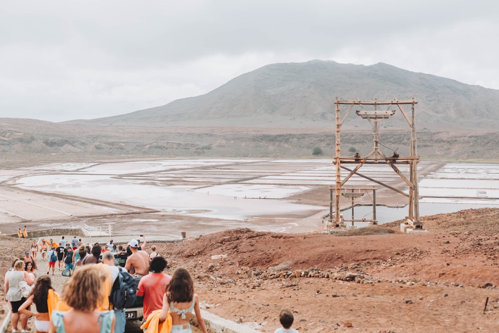 a group of people walking down a dirt road