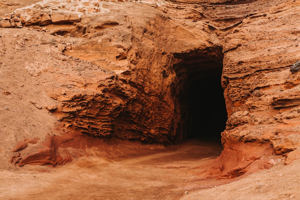 a cave entrance in the side of a mountain