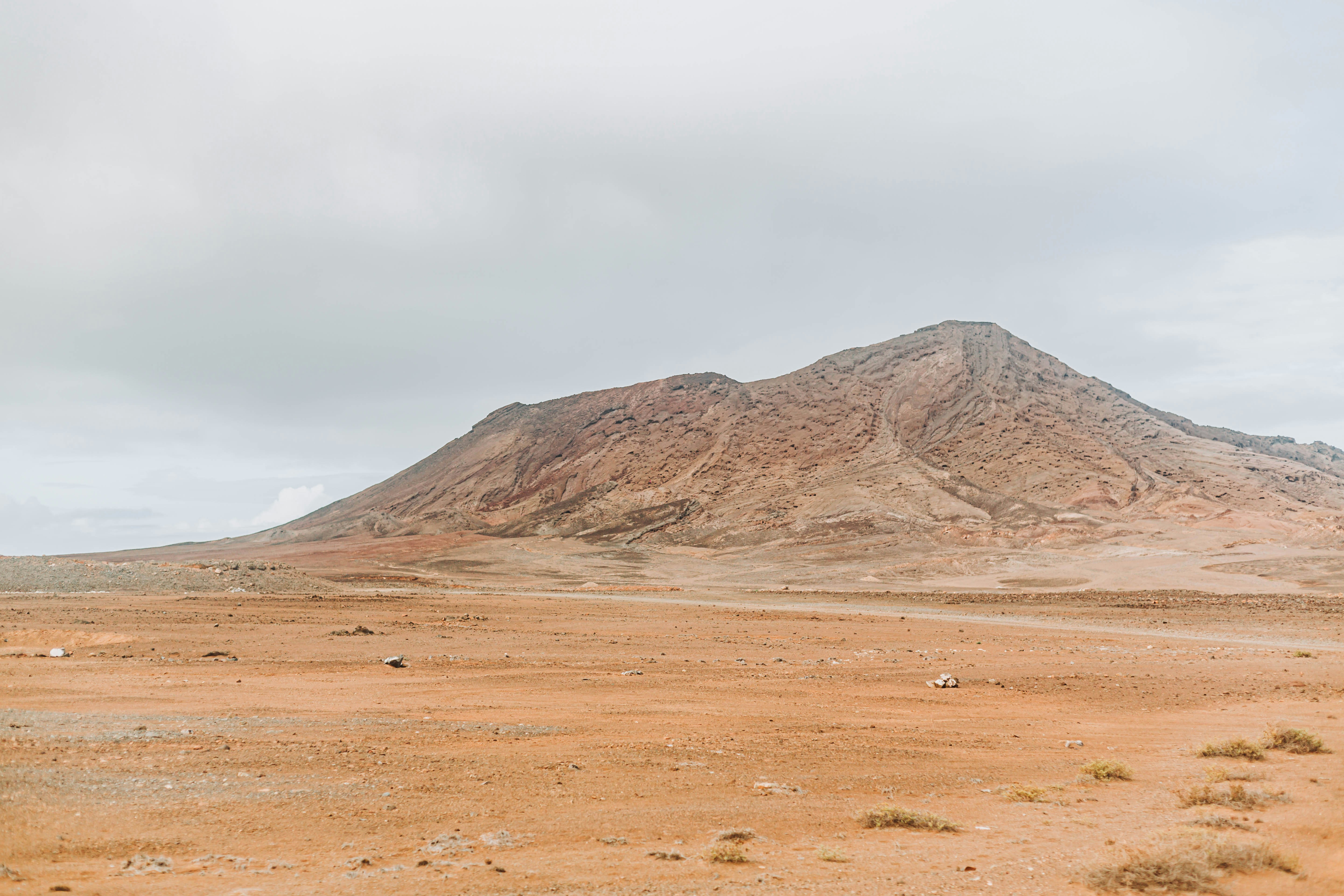 a large mountain in the middle of a desert, 