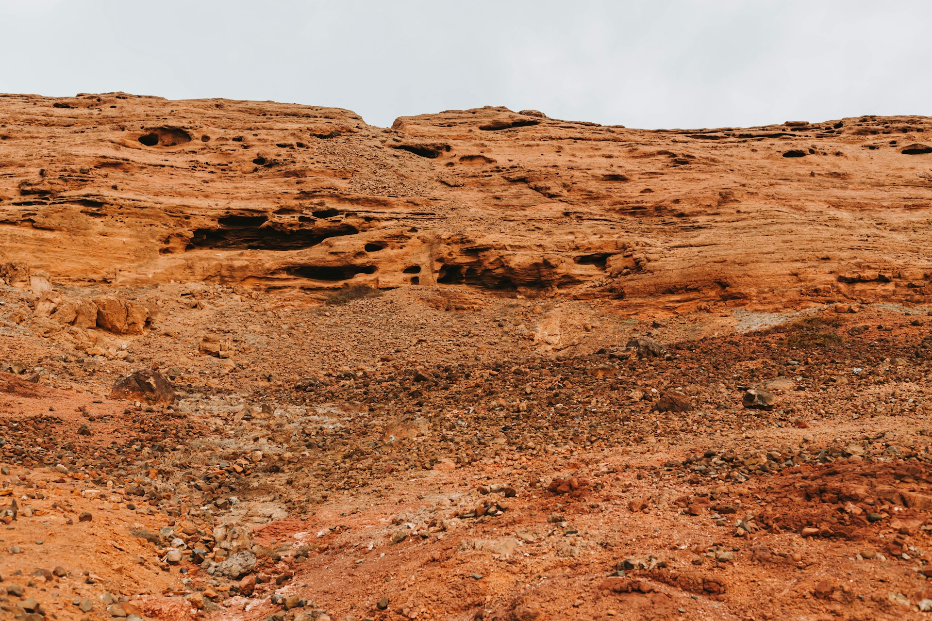 a rock formation with a sky in the background