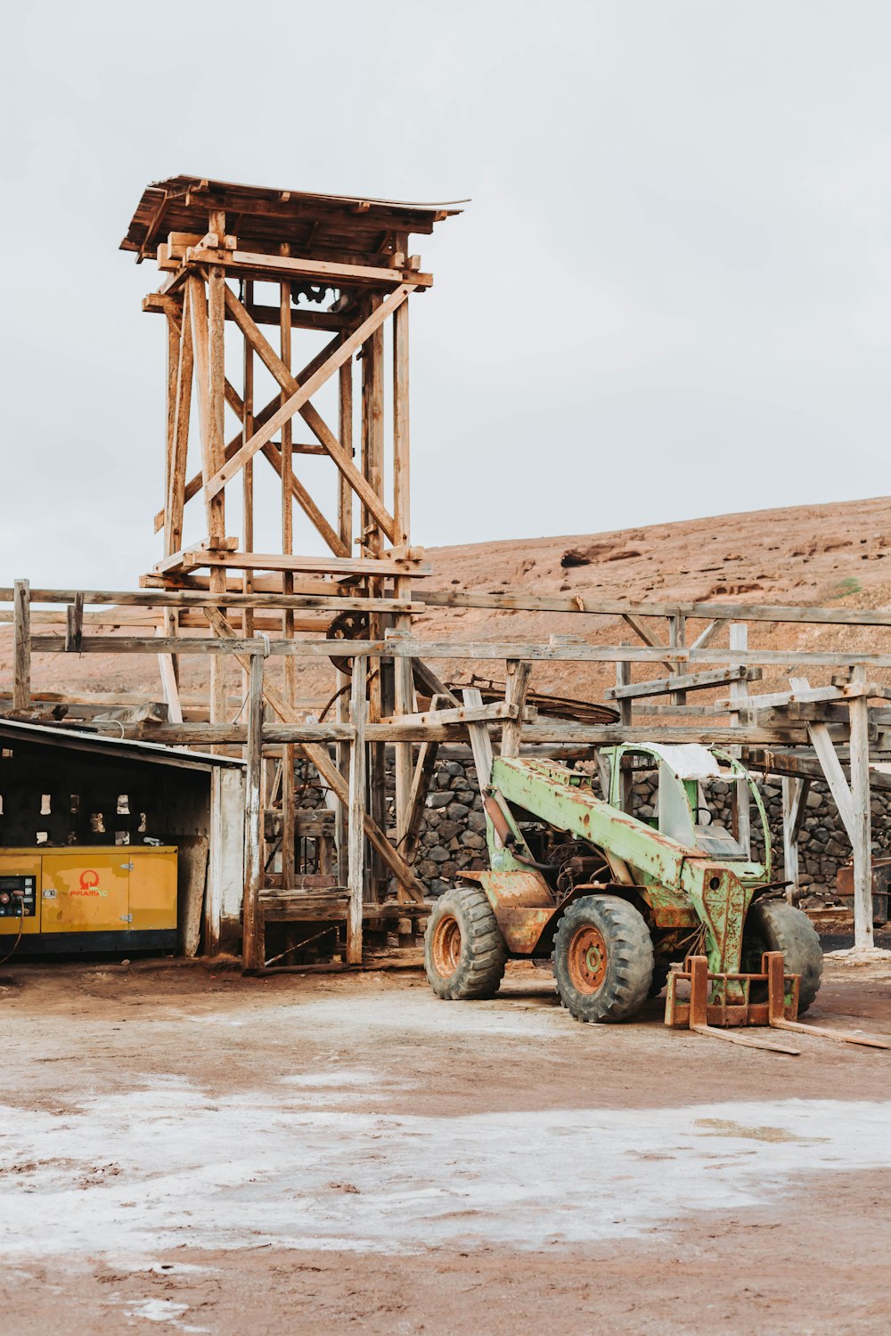 a tractor parked in front of a wooden structure