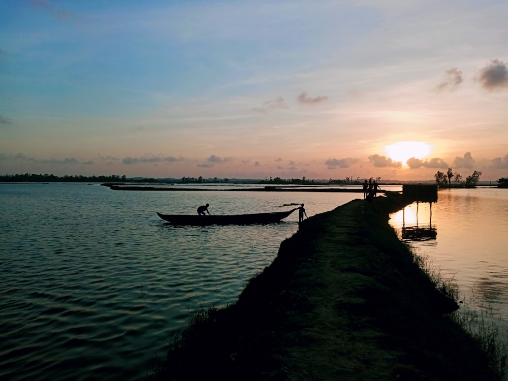 a person standing in a boat on a body of water