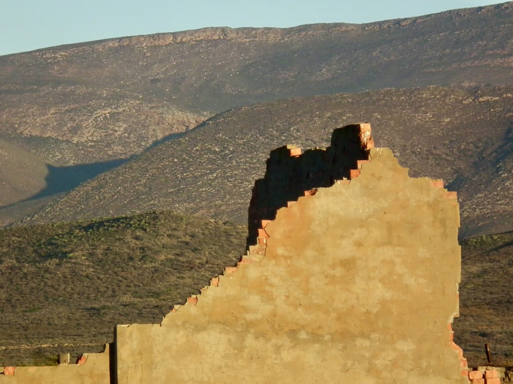 a building with mountains in the background