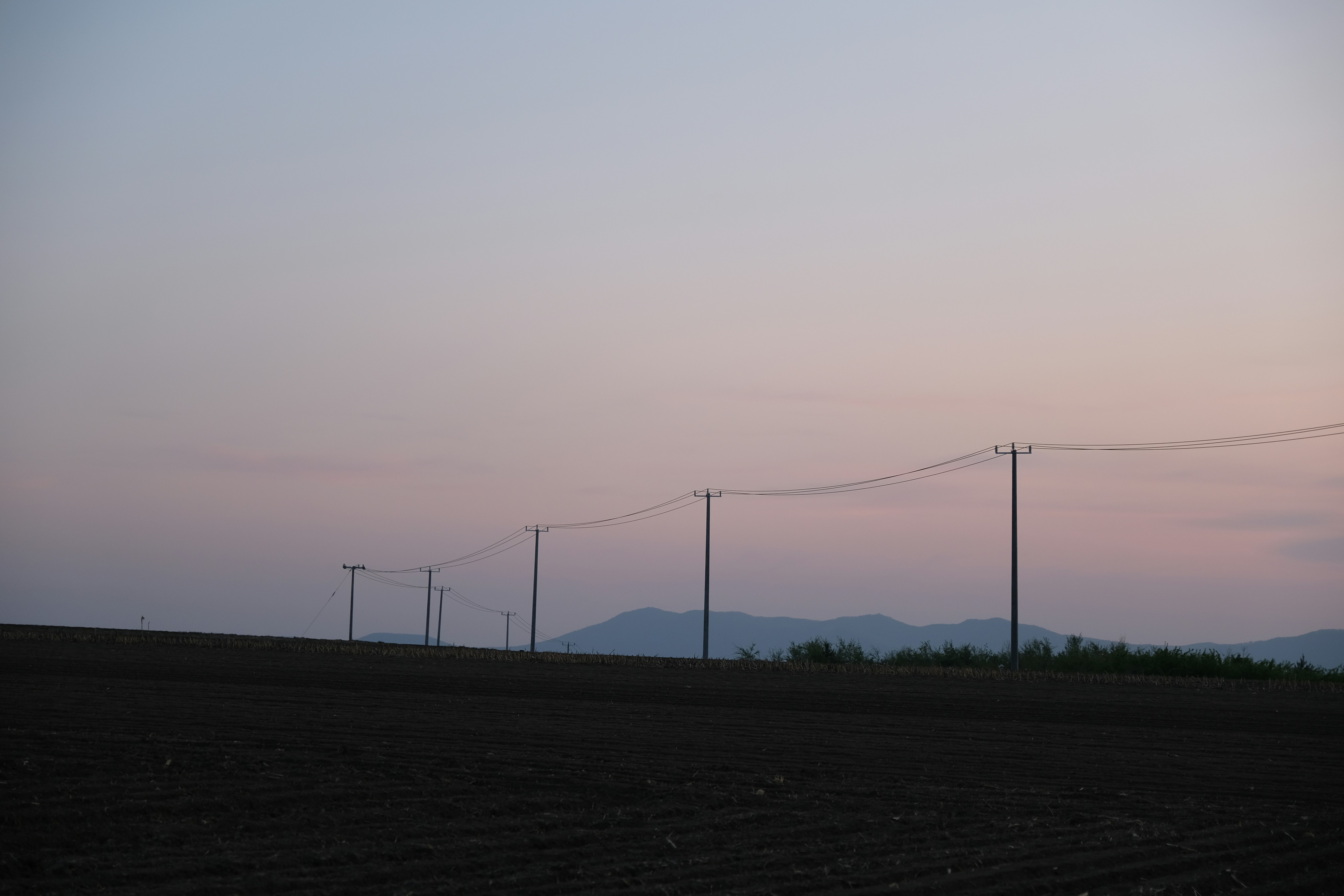 woman wearing yellow long-sleeved dress under white clouds and blue sky during daytime