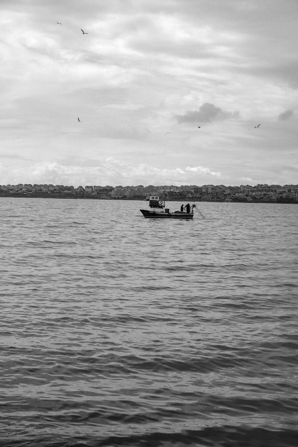 a black and white photo of a boat in the water