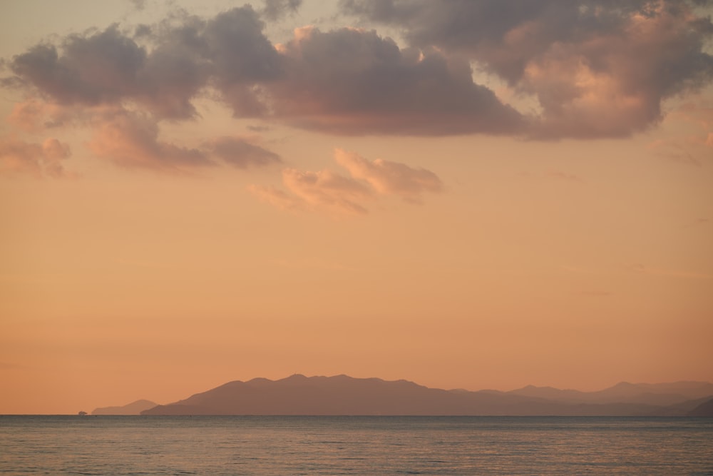 a large body of water under a cloudy sky