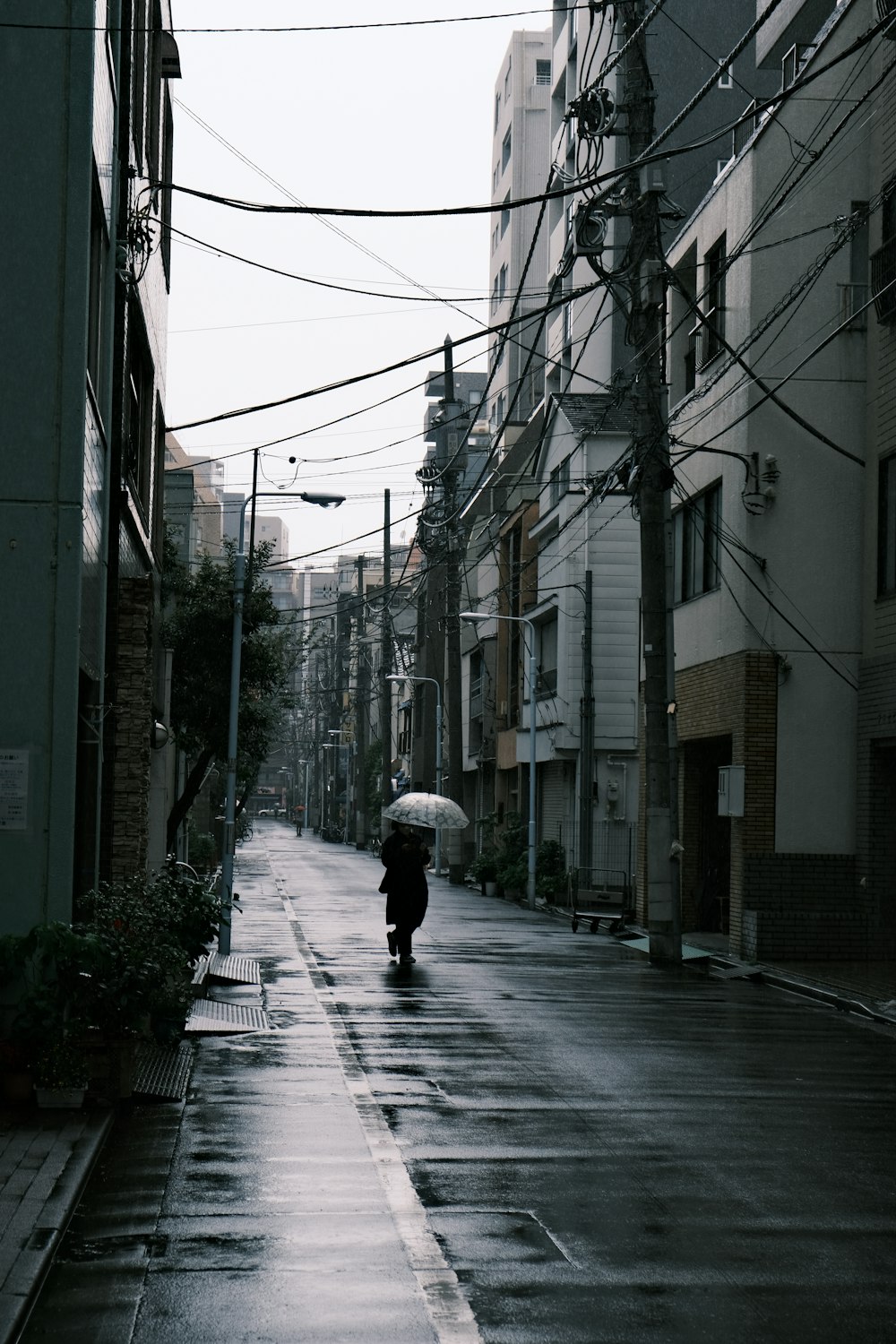 a person walking down a street holding an umbrella