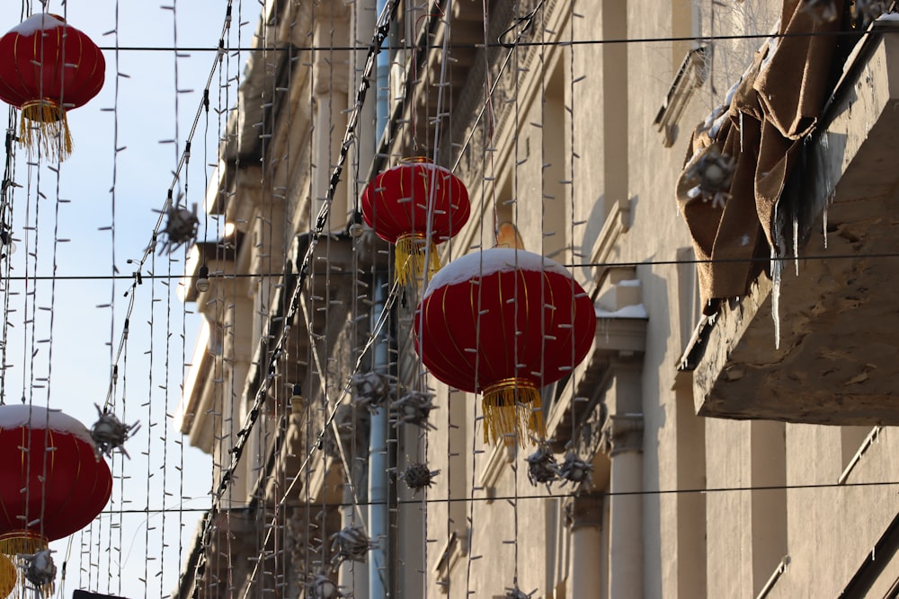 red and yellow lanterns hanging from a building