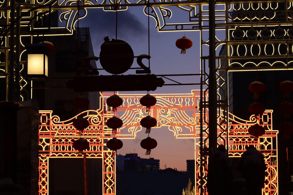 a chinese gate with lanterns hanging from it