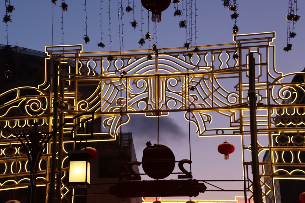 a large metal gate with lanterns hanging from it's sides