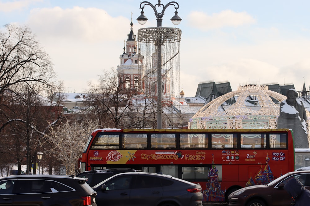 a red double decker bus driving down a street