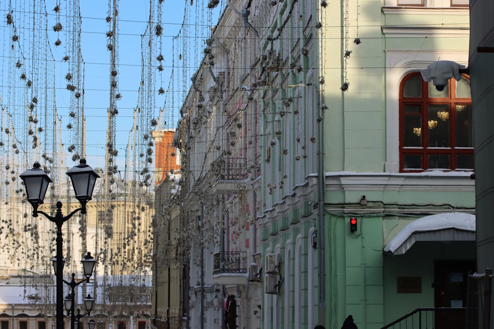 a row of buildings with lots of lights hanging from them