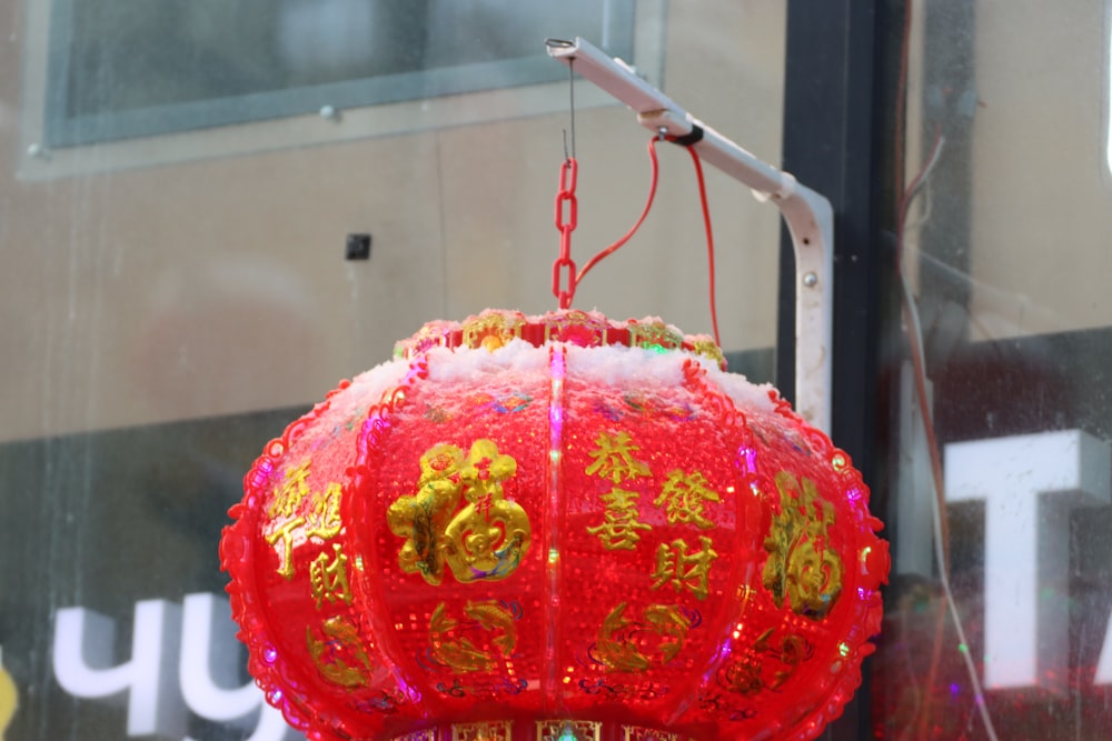 a red chinese lantern hanging from a pole