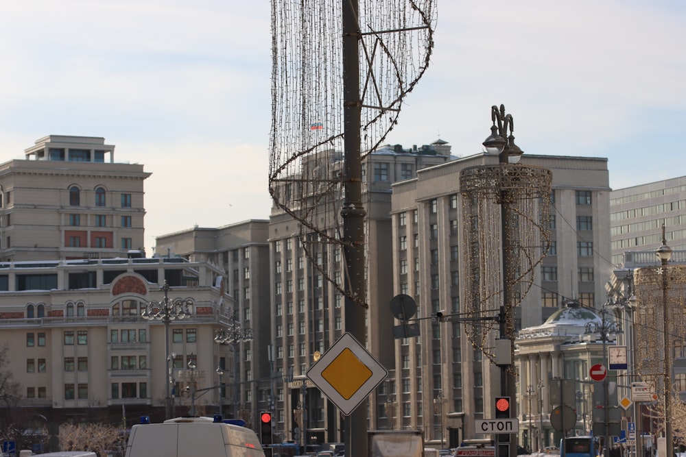 a city street filled with lots of traffic next to tall buildings