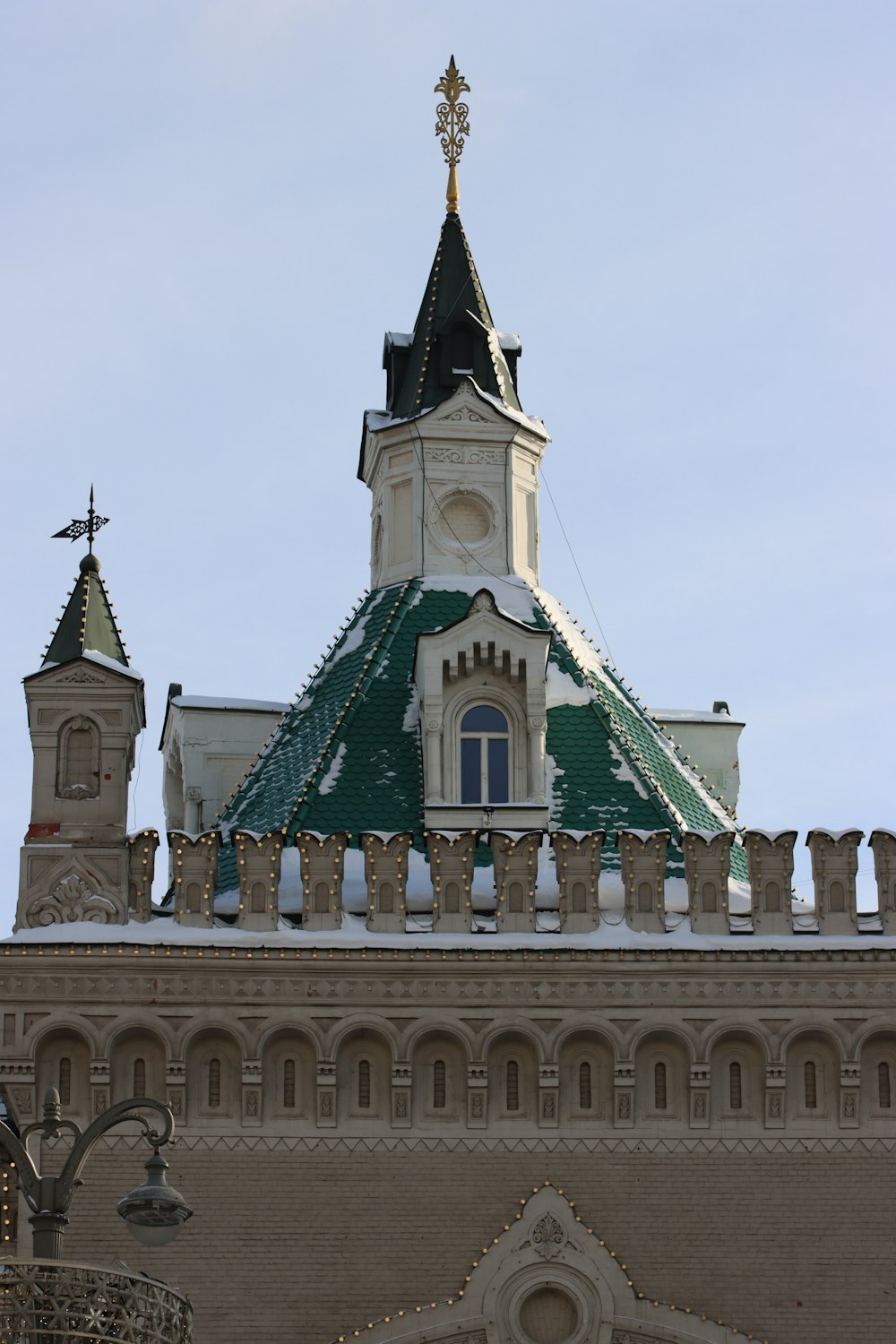 a large building with a green roof and a clock tower