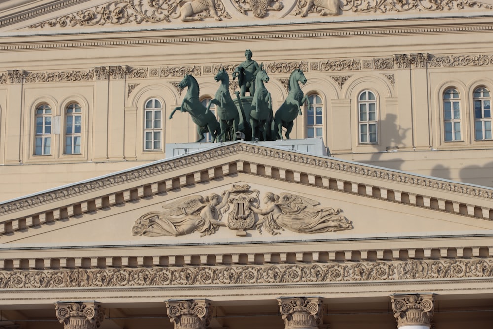 a large building with statues on top of it