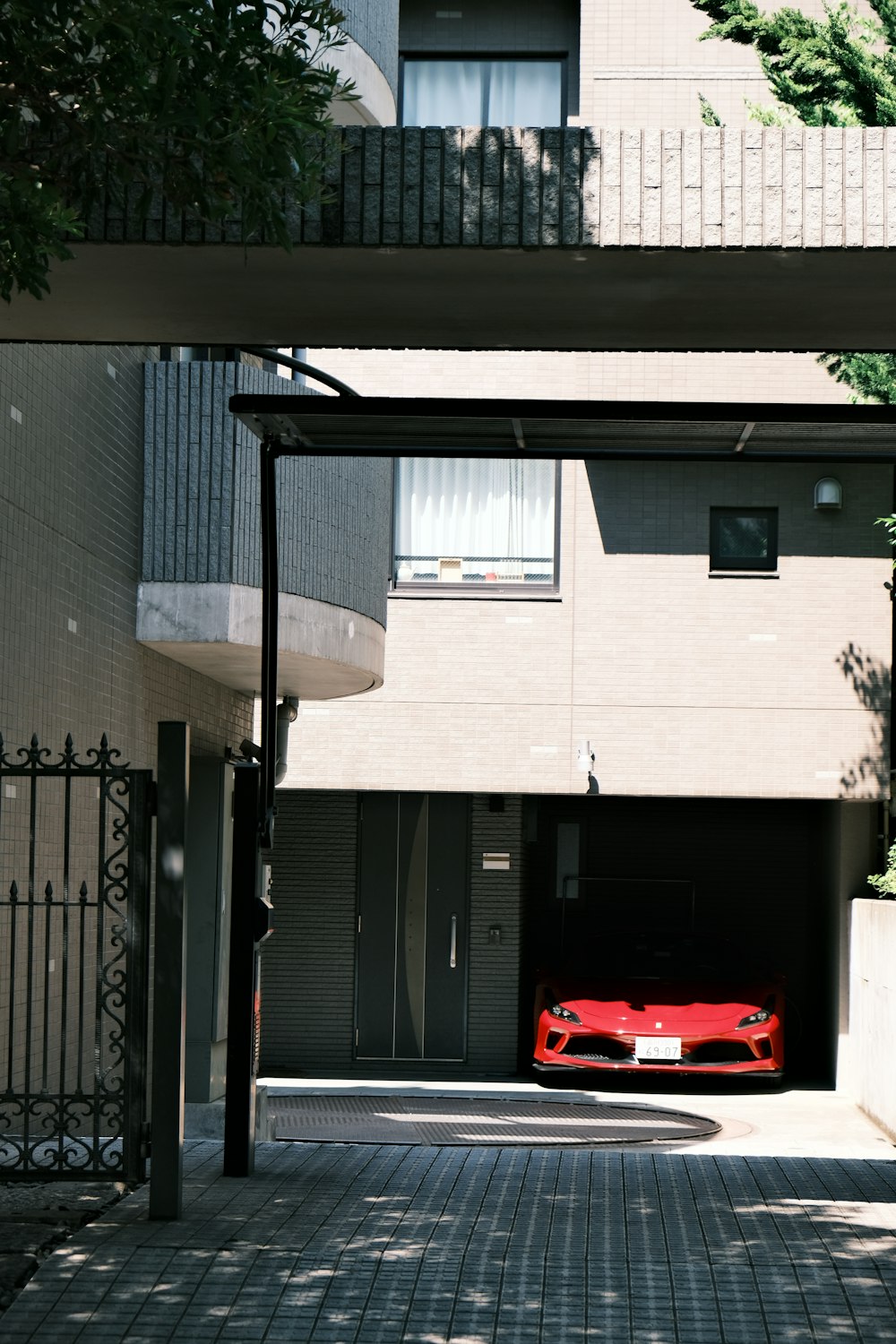 a red car is parked in a parking garage