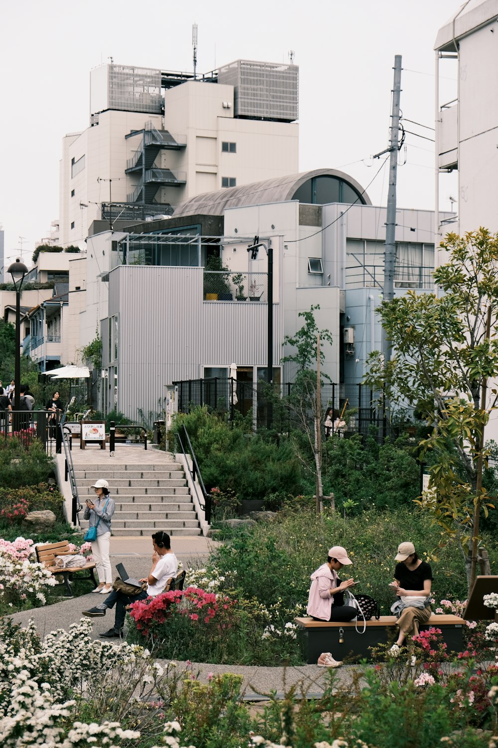 a group of people sitting on benches in a park