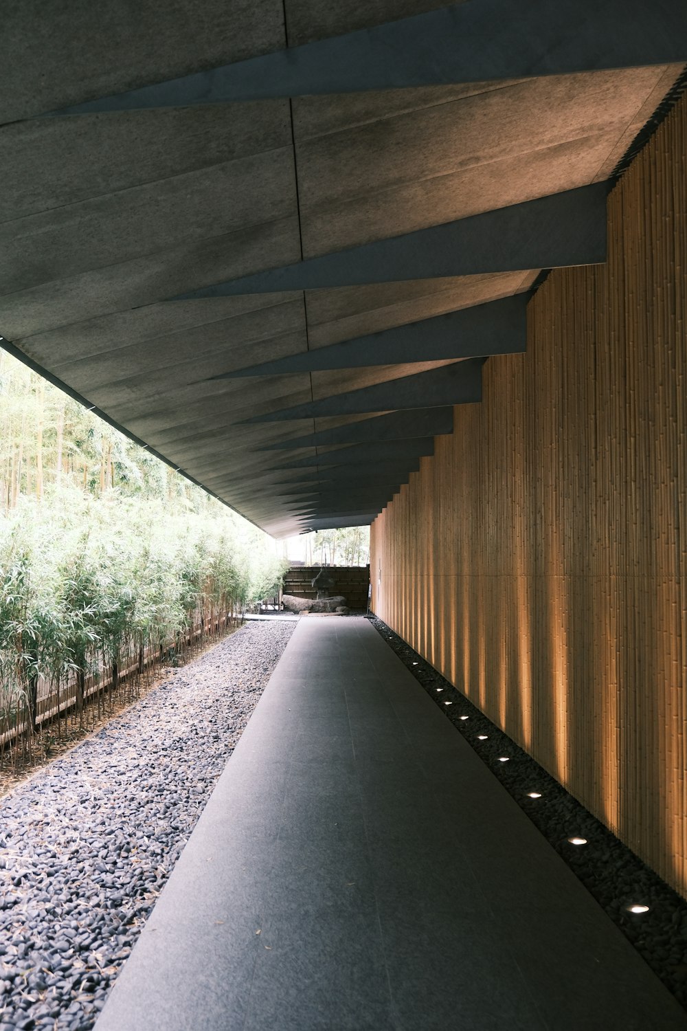 a long walkway with a train on the side of it