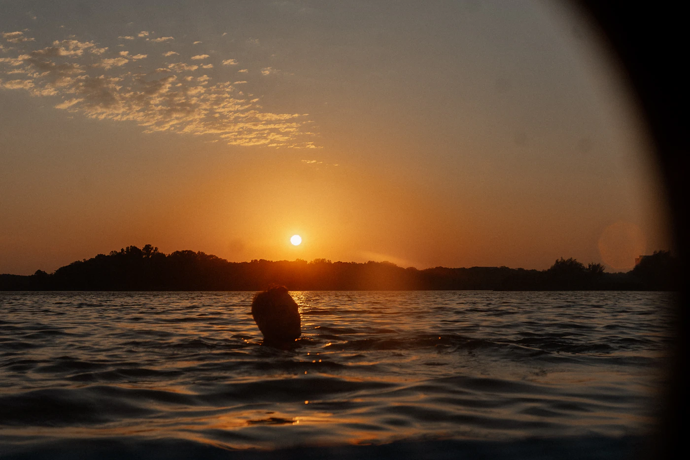 Swimming at sunset in summer