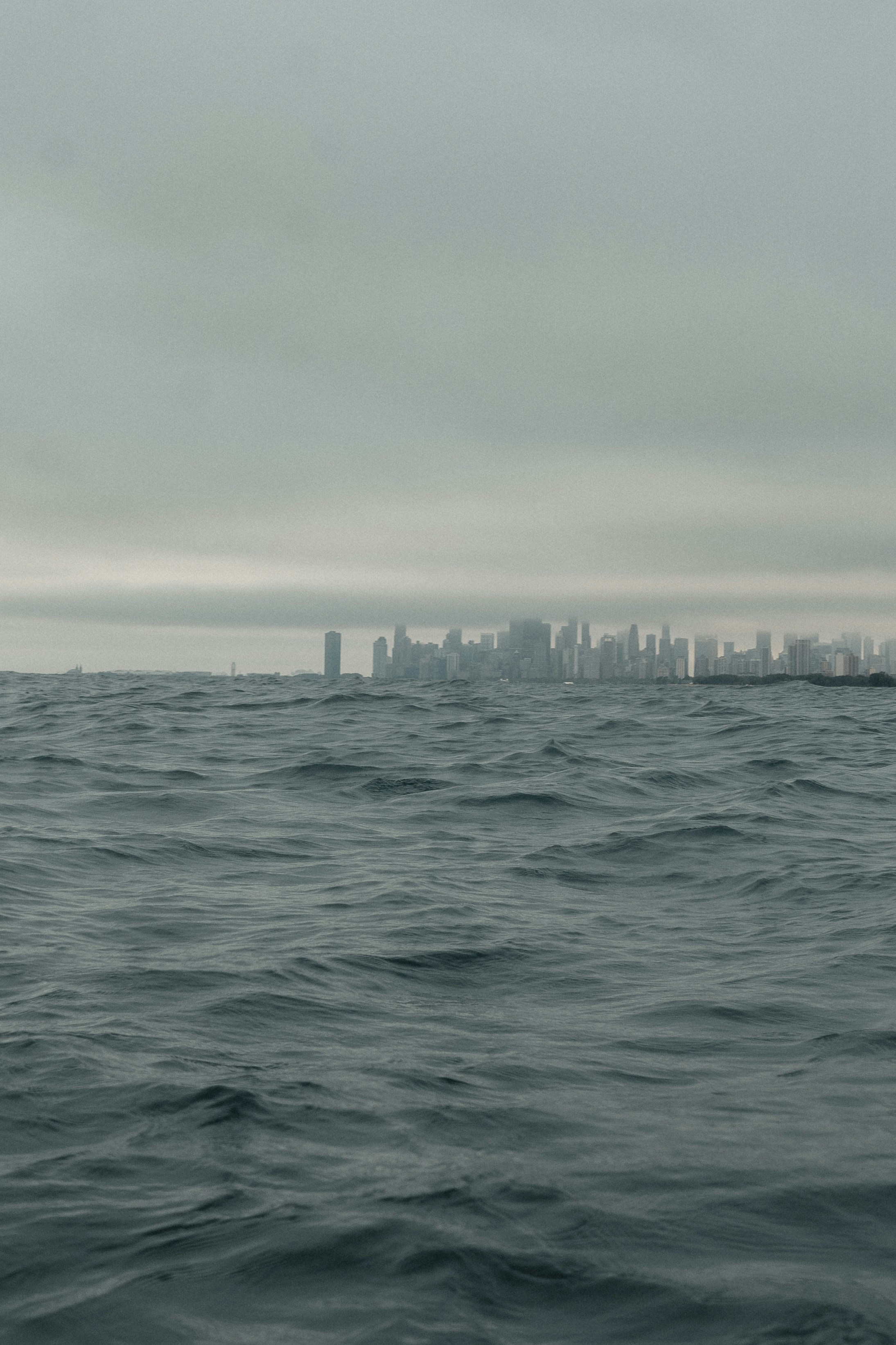 a large body of water with a city in the distance
