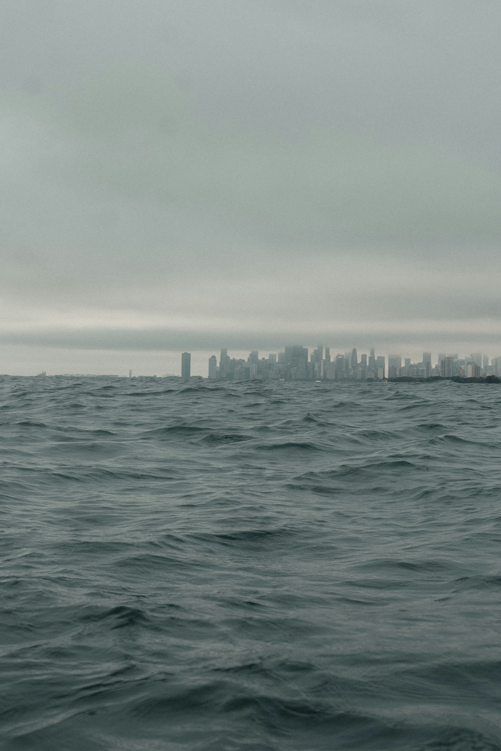 a large body of water with a city in the distance