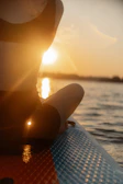 a person sitting on a surfboard in the water