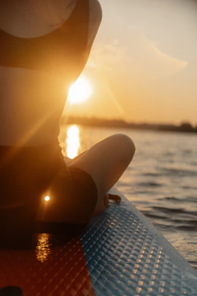 a person sitting on a surfboard in the water