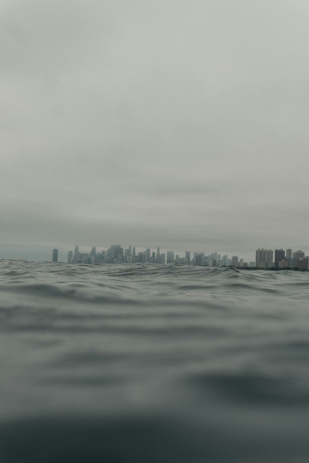 a large body of water with a city in the background