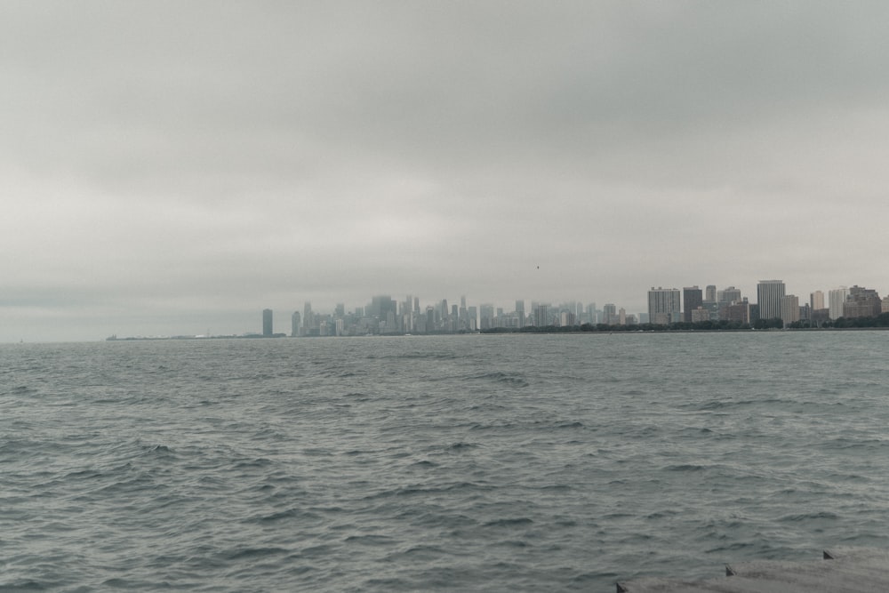 a large body of water with a city in the background