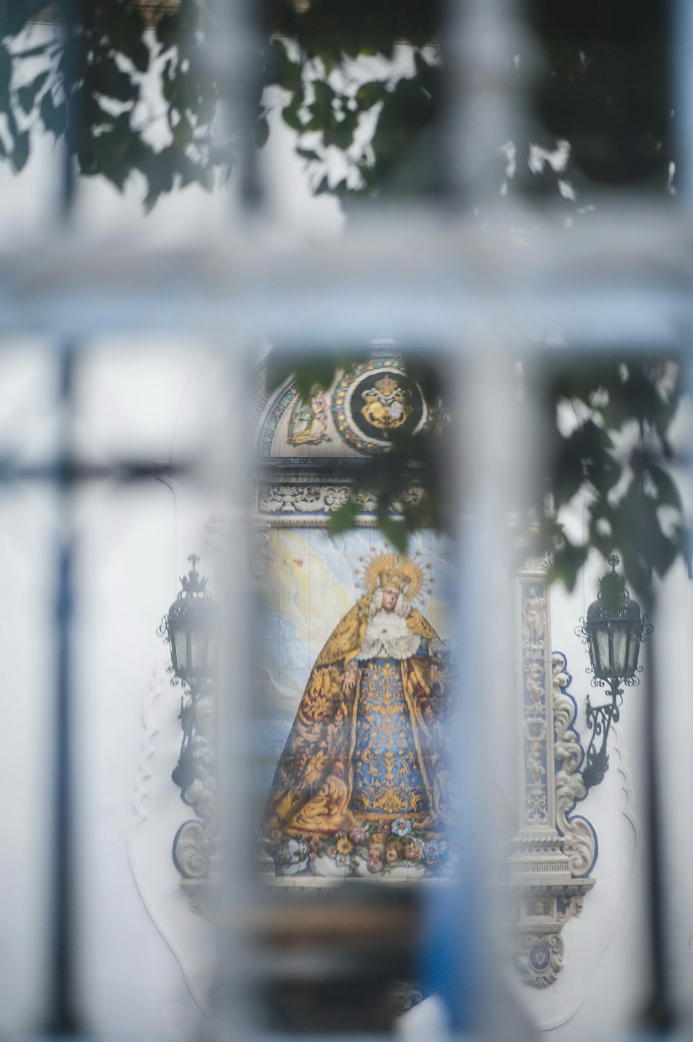 a reflection of a statue in a window