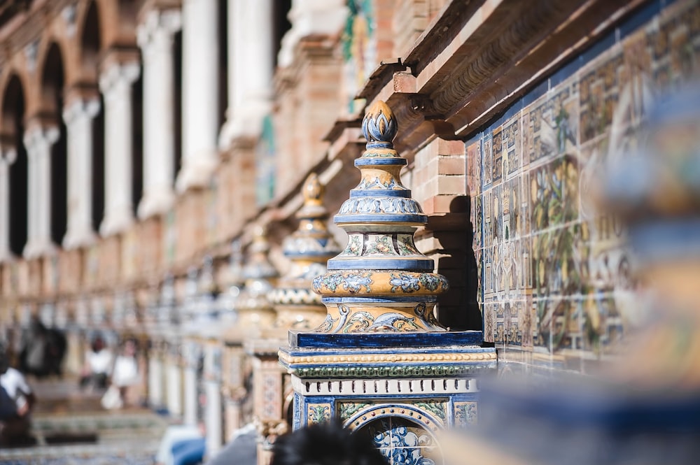 a row of blue and gold tiles on the side of a building